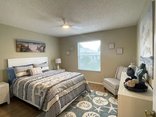 a bedroom with a bed and glass window
