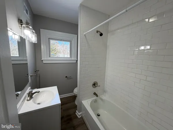 a bathroom with a bathtub a sink and a shower