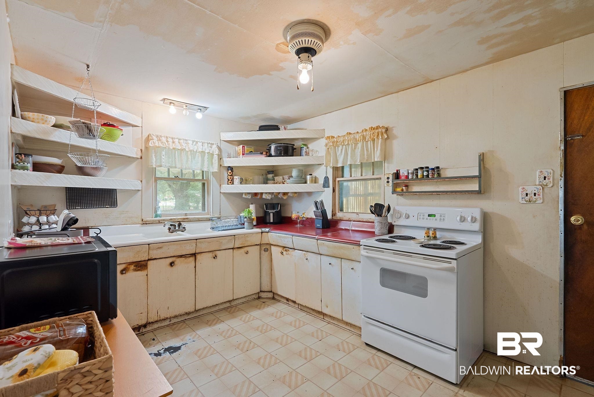 615 West Section Avenue Foley, AL 36535 - Photo 14 of 40 Kitchen featuring an electric range, white cabinetry, a single basin sink, and an exposed light fixture