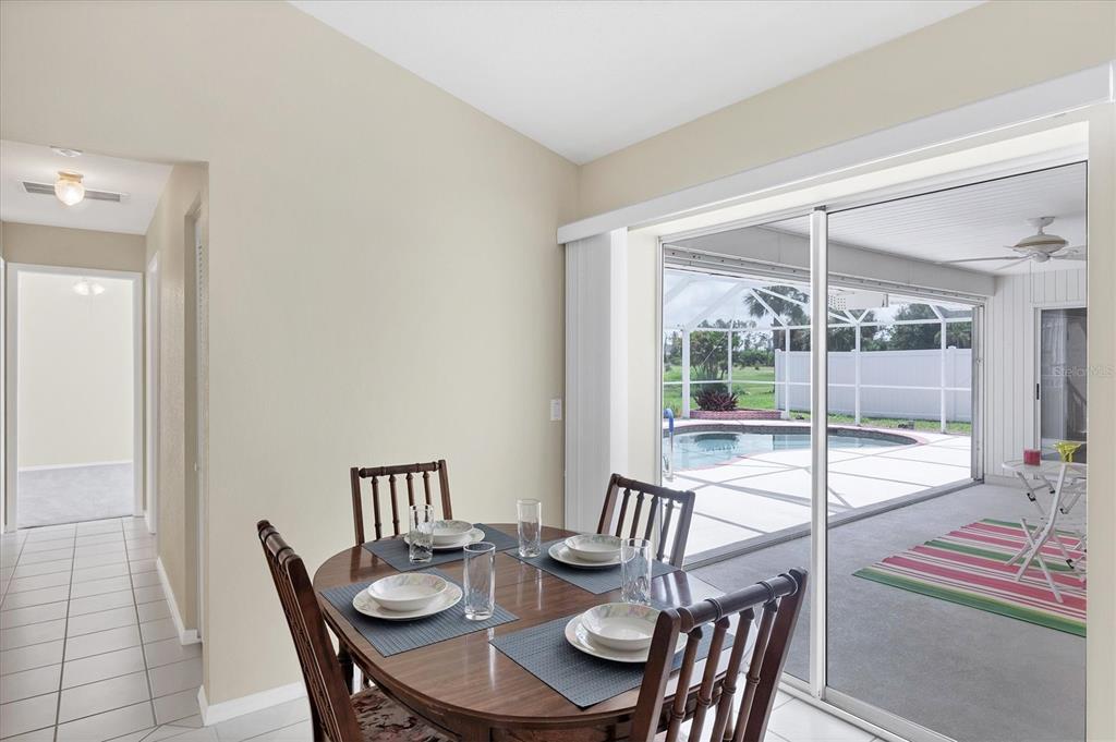 63 Clubhouse Road Rotonda West, FL 33947 - Photo 11 of 44 a view of a dining room with furniture wooden floor and next to a window