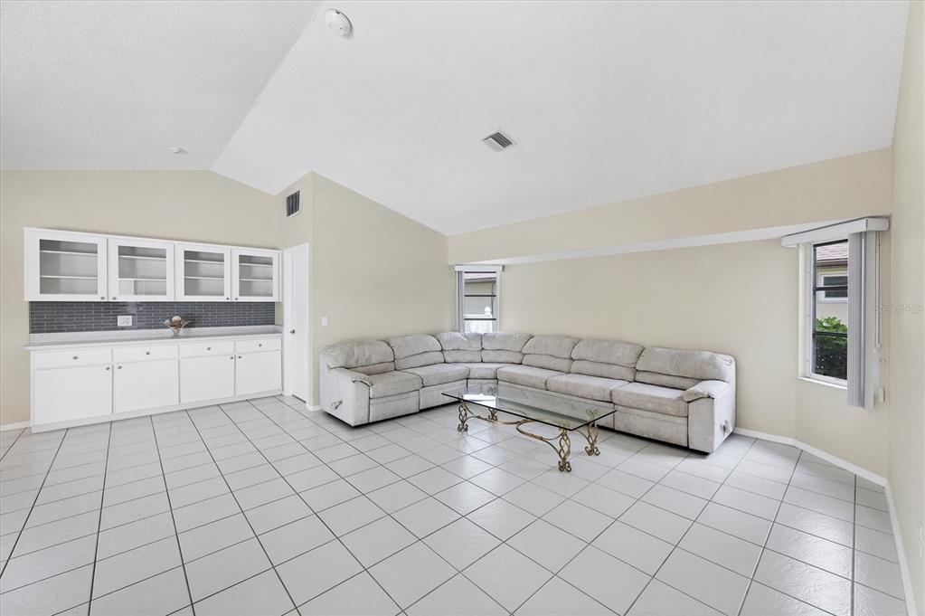 63 Clubhouse Road Rotonda West, FL 33947 - Photo 13 of 44 a living room with furniture and wooden floor
