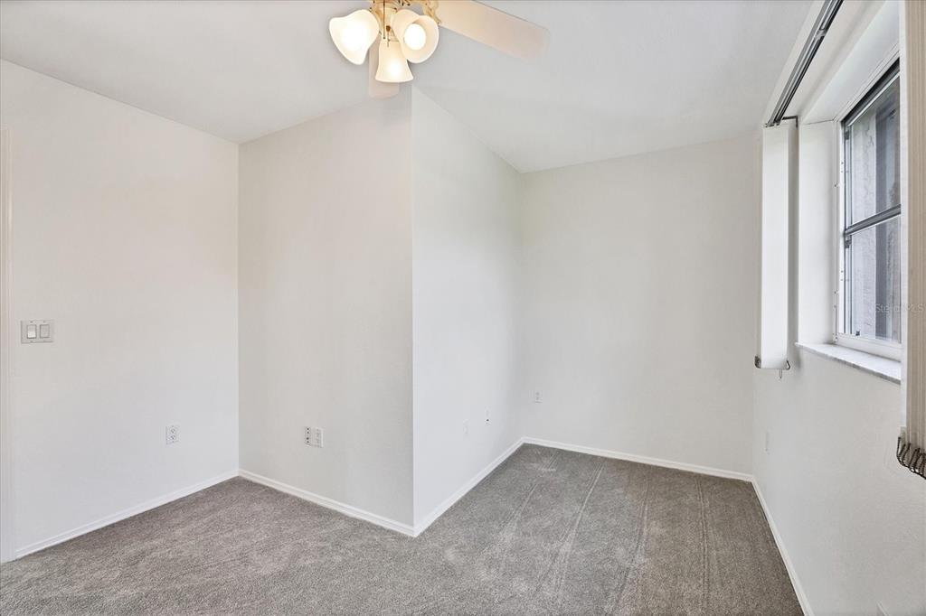 63 Clubhouse Road Rotonda West, FL 33947 - Photo 17 of 44 an empty room with a window