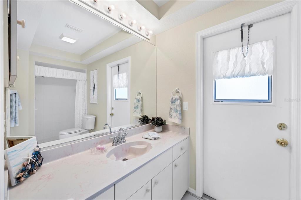 63 Clubhouse Road Rotonda West, FL 33947 - Photo 18 of 44 a bathroom with a double vanity sink mirror and