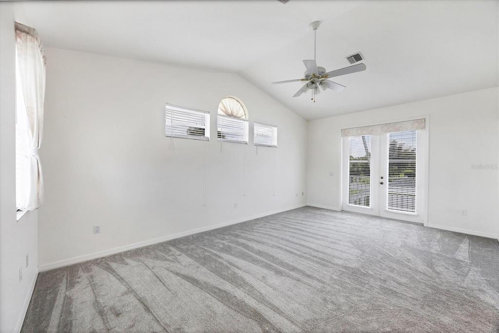 63 Clubhouse Road Rotonda West, FL 33947 - Photo 20 of 44 an empty room with windows and fan