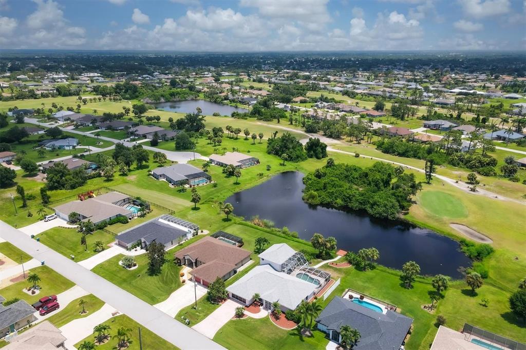 63 Clubhouse Road Rotonda West, FL 33947 - Photo 2 of 44 an aerial view of residential houses with outdoor space