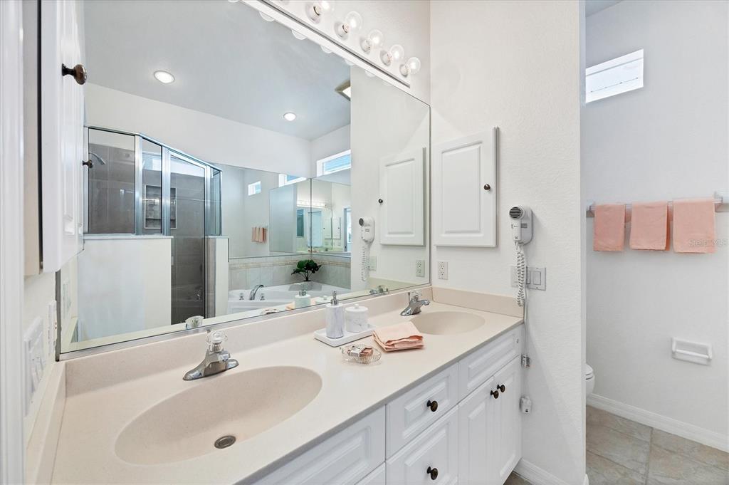 63 Clubhouse Road Rotonda West, FL 33947 - Photo 23 of 44 a bathroom with a double vanity sink mirror and double
