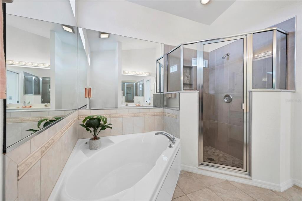 63 Clubhouse Road Rotonda West, FL 33947 - Photo 24 of 44 a bathroom with a tub shower vanity and a sink