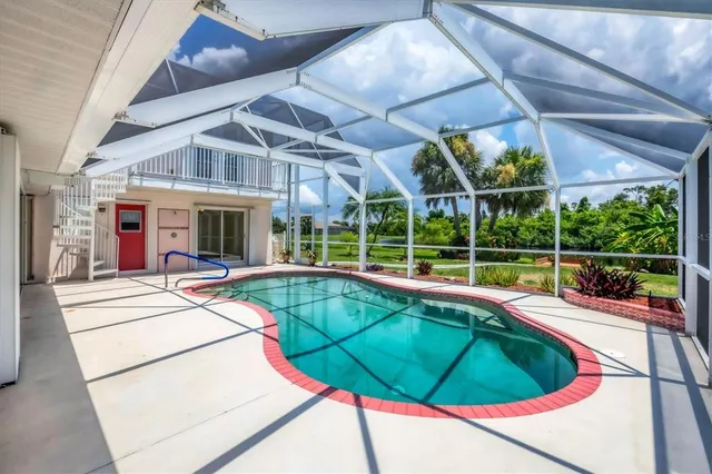 a view of a backyard with a swimming pool