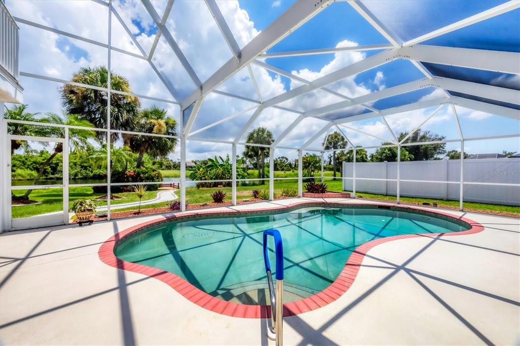 63 Clubhouse Road Rotonda West, FL 33947 - Photo 28 of 44 a view of a backyard with a swimming pool