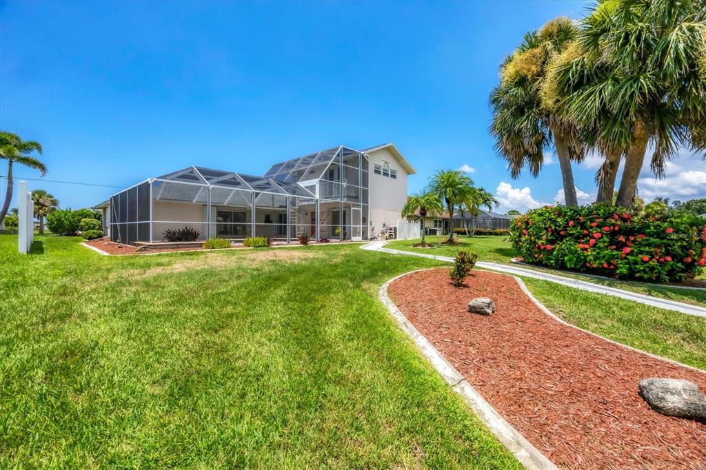 63 Clubhouse Road Rotonda West, FL 33947 - Photo 34 of 44 a view of a house with a yard and sitting area