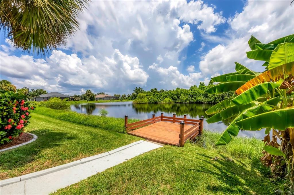 63 Clubhouse Road Rotonda West, FL 33947 - Photo 35 of 44 a backyard of a house with lots of green space