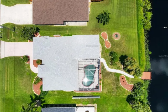 a view of a swimming pool with a garden and plants