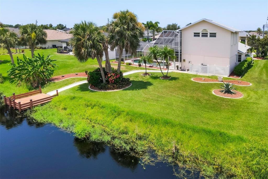 63 Clubhouse Road Rotonda West, FL 33947 - Photo 39 of 44 a view of a swimming pool with a garden and plants