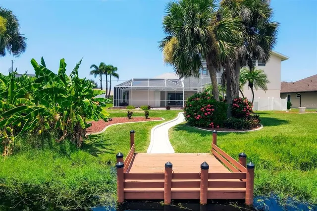 an aerial view of residential houses with outdoor space and river