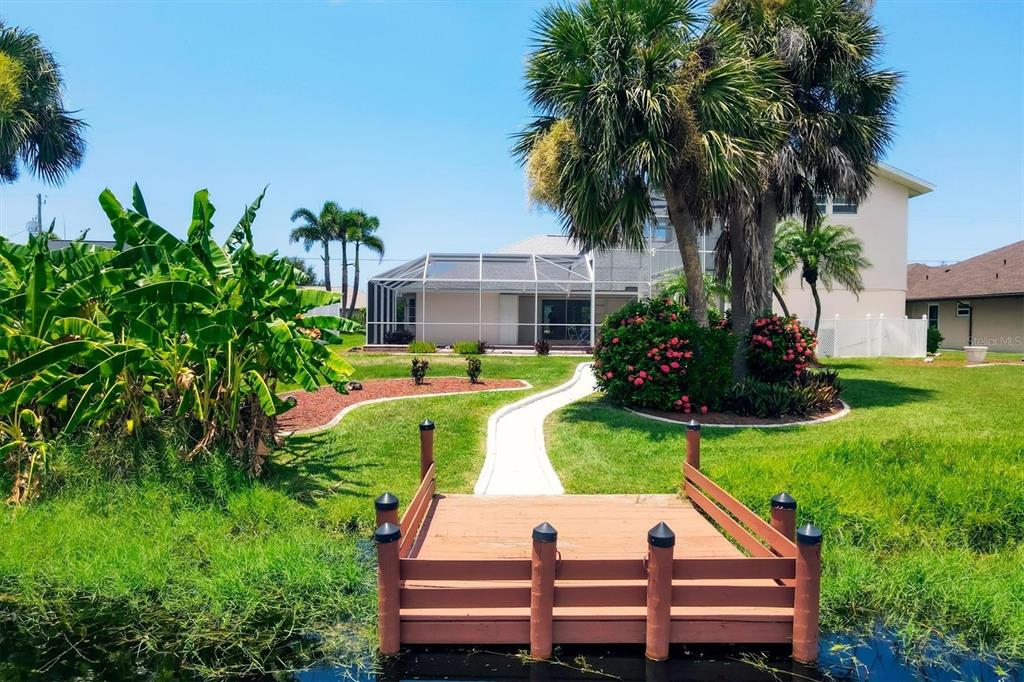 63 Clubhouse Road Rotonda West, FL 33947 - Photo 40 of 44 a view of a sitting area with chairs and a yard
