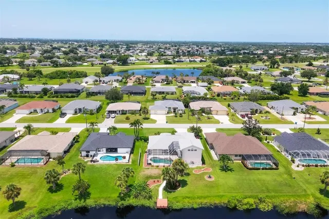 an aerial view of residential houses with outdoor space