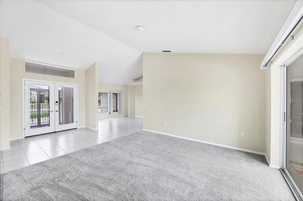 63 Clubhouse Road Rotonda West, FL 33947 - Photo 5 of 44 a view of a big room with wooden floor and a kitchen