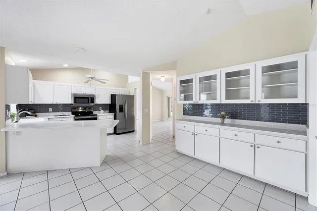 a kitchen with a sink stainless steel appliances and cabinets