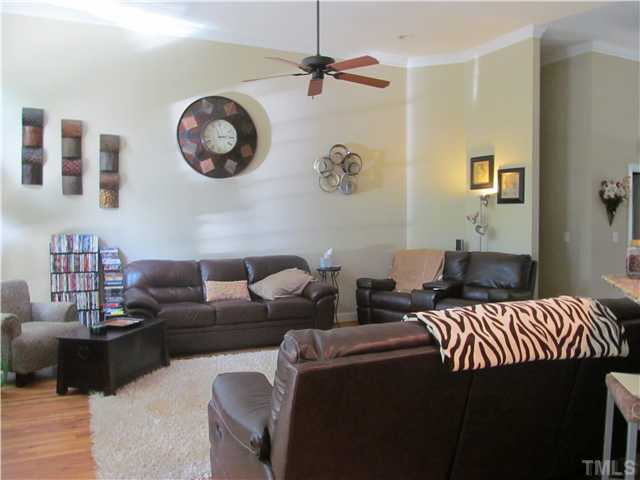 109 Rivers Edge Court Timberlake, NC 27583 - Photo 3 of 18 a living room with furniture a wall paintings and a window