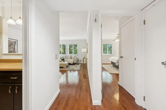 a living room with furniture and a wooden floor