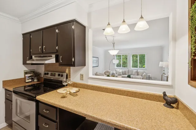a kitchen with a sink cabinets and window
