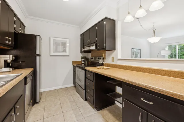 a kitchen with a sink appliances and cabinets