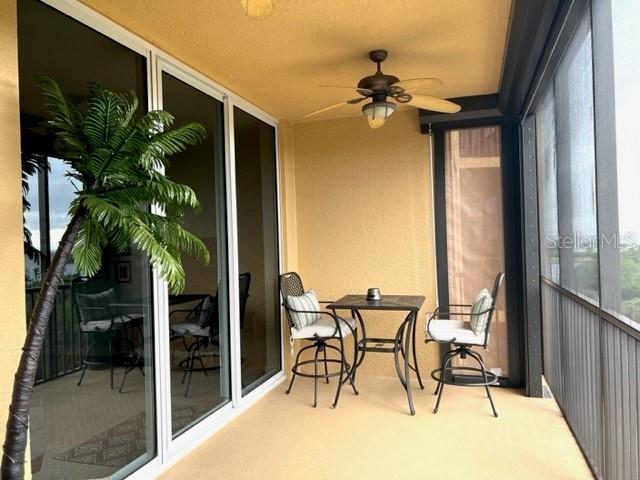 3321 Sunset Key Circle, Unit 308 Punta Gorda, FL 33955 - Photo 11 of 66 a view of a porch with a table and chairs and potted plants