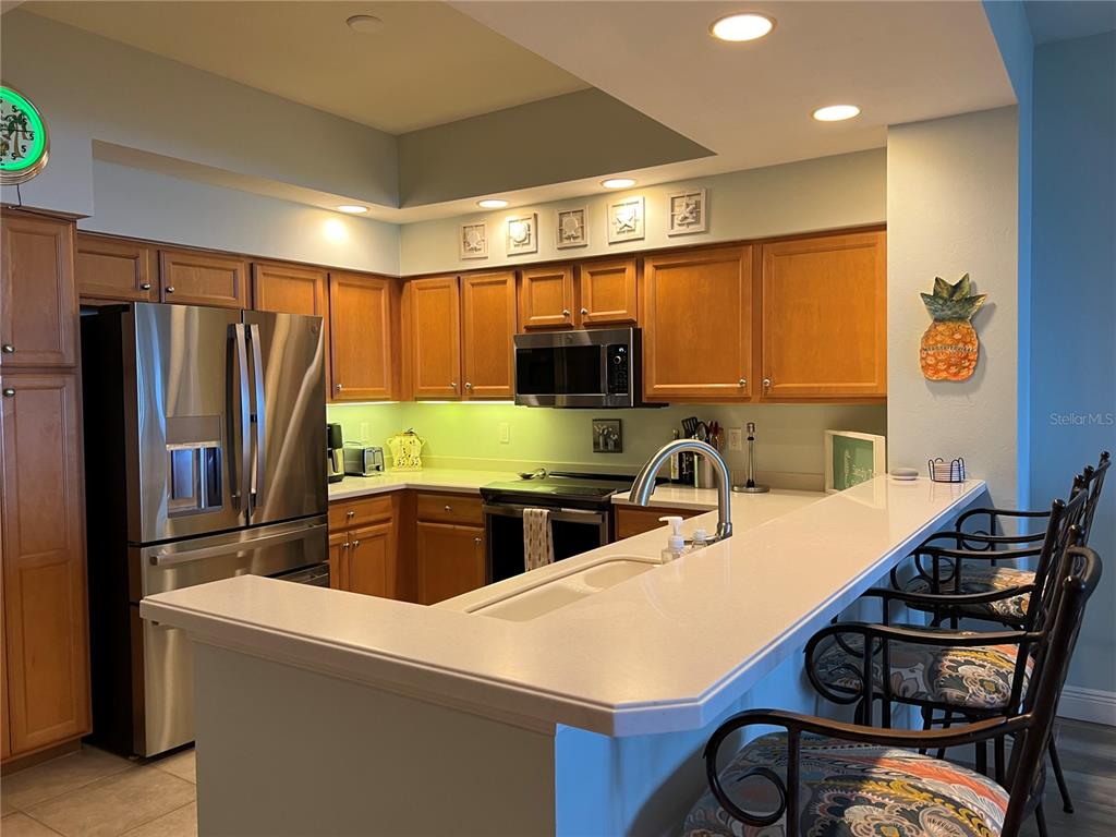 3321 Sunset Key Circle, Unit 308 Punta Gorda, FL 33955 - Photo 21 of 66 a kitchen with stainless steel appliances a stove a refrigerator a sink and a refrigerator