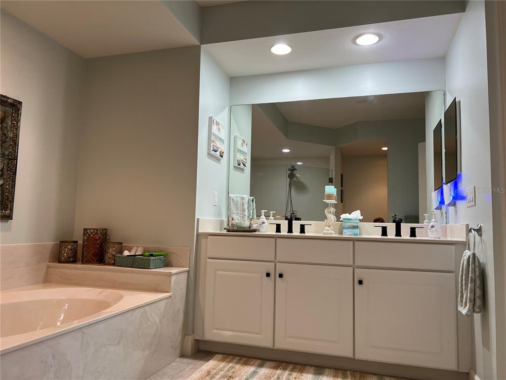 3321 Sunset Key Circle, Unit 308 Punta Gorda, FL 33955 - Photo 28 of 66 a bathroom with a bathtub a double vanity sink and mirror