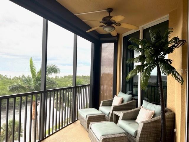 3321 Sunset Key Circle, Unit 308 Punta Gorda, FL 33955 - Photo 5 of 66 a living room with furniture and a floor to ceiling window