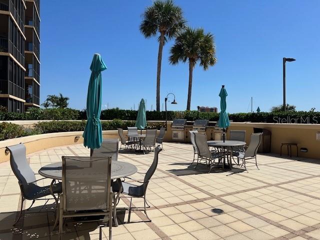 3321 Sunset Key Circle, Unit 308 Punta Gorda, FL 33955 - Photo 64 of 66 a view of a patio with a table and chairs and potted plants