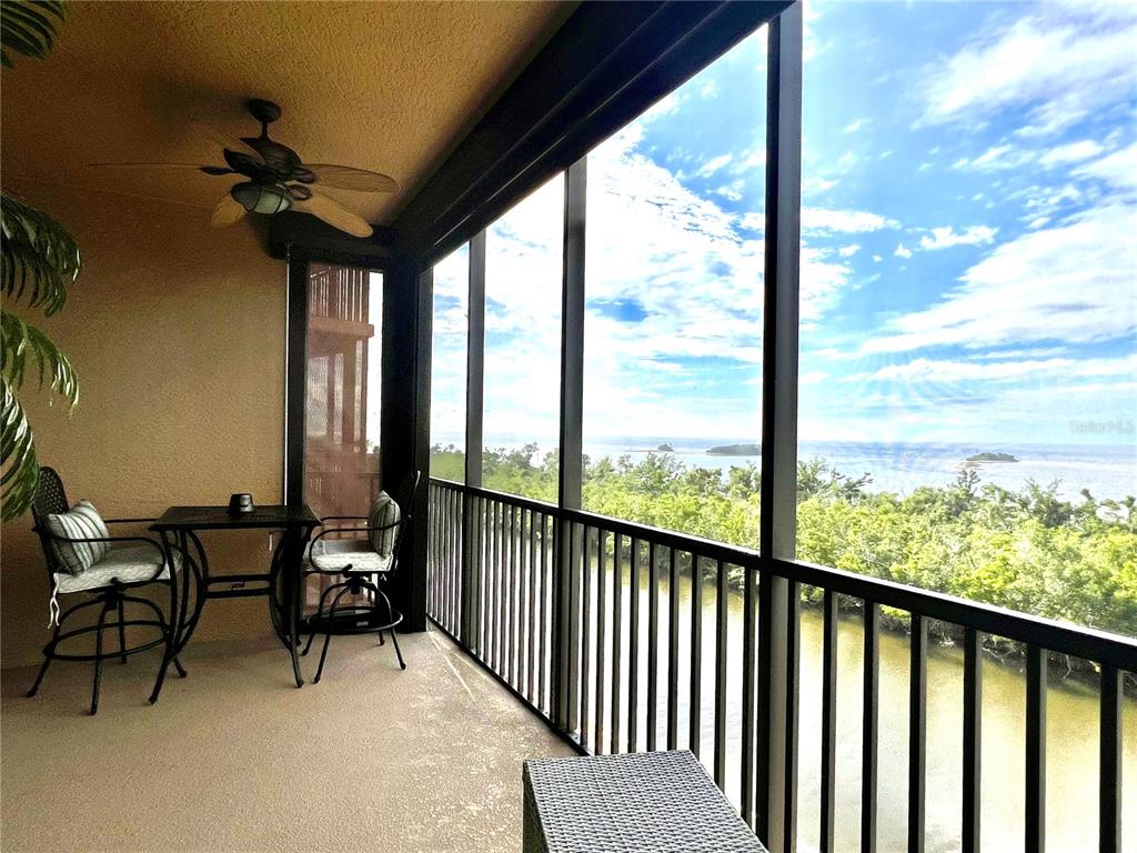 3321 Sunset Key Circle, Unit 308 Punta Gorda, FL 33955 - Photo 10 of 66 a view of a two chairs in the balcony next to a yard