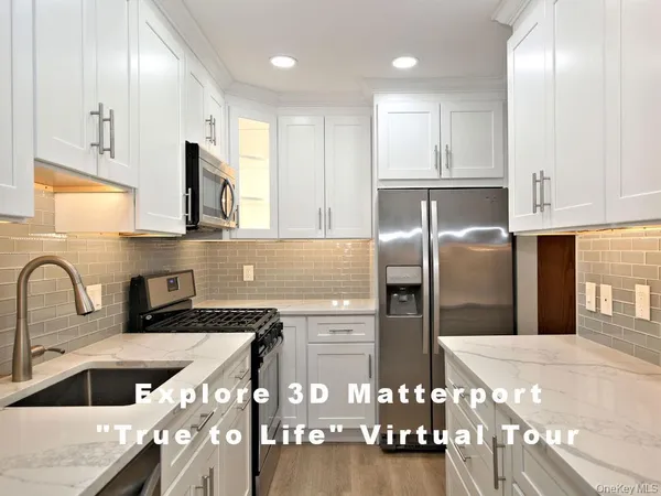 a kitchen with stainless steel appliances granite countertop a sink a stove and refrigerator