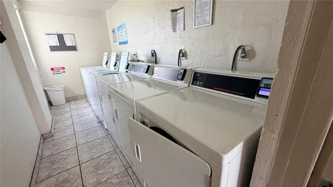 a room with washing machine and sink