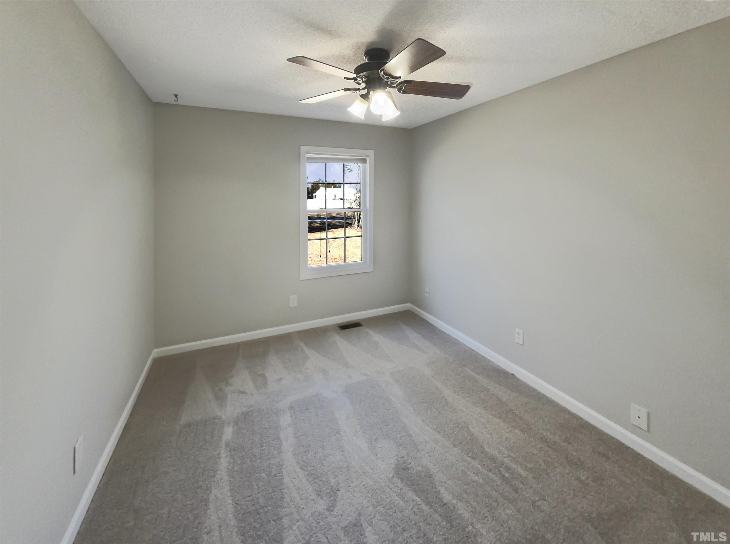 8889 Mt Pleasant Church Road Willow Spring, NC 27592 - Photo 12 of 18 wooden floor in an empty room with a window