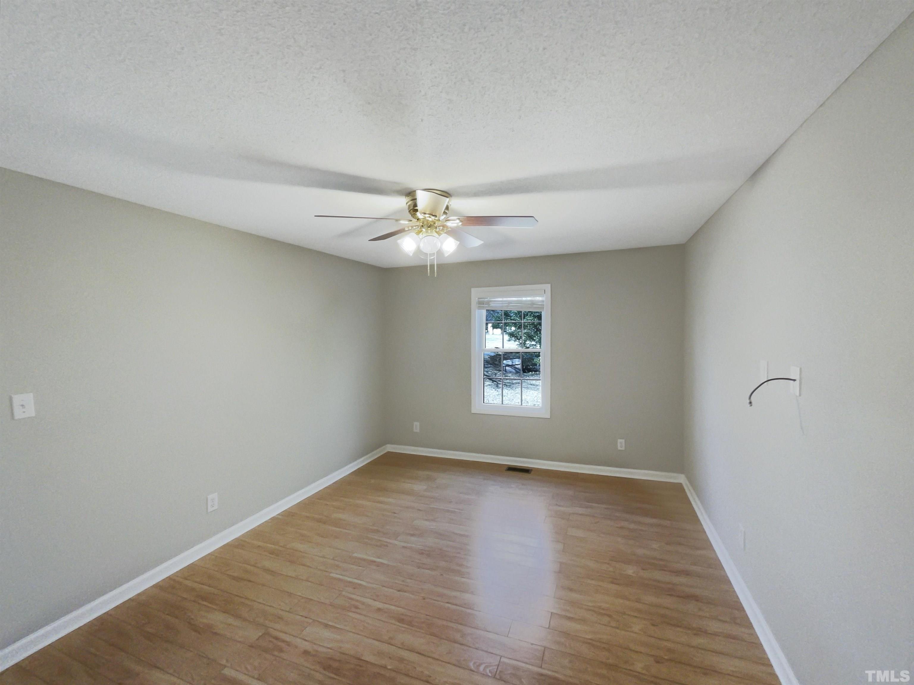 8889 Mt Pleasant Church Road Willow Spring, NC 27592 - Photo 15 of 18 wooden floor in an empty room with a window