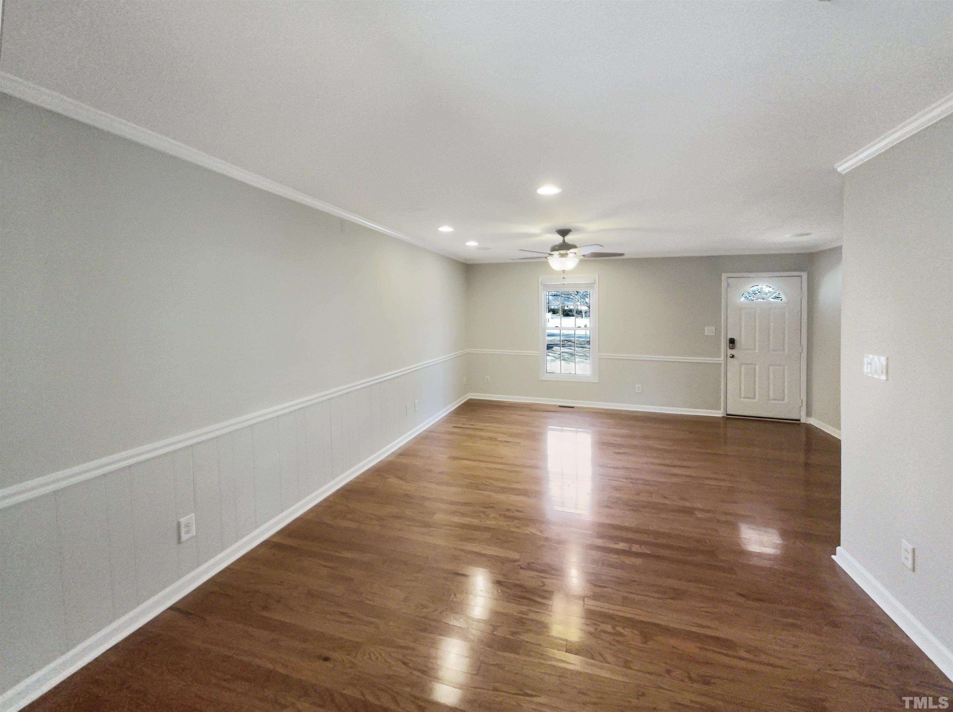 8889 Mt Pleasant Church Road Willow Spring, NC 27592 - Photo 3 of 18 a view of empty room with wooden floor and windows
