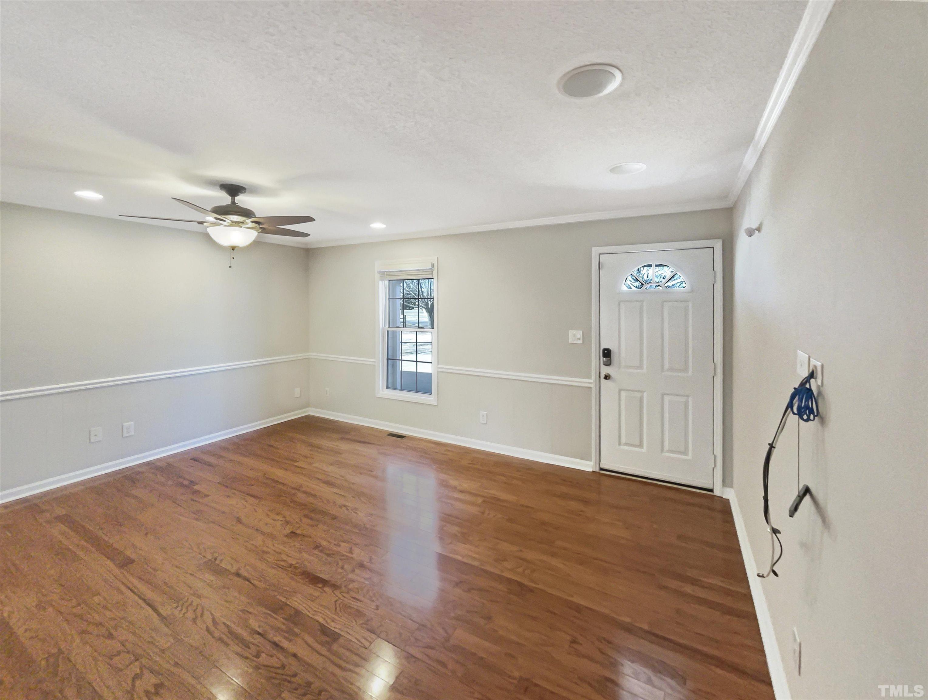 8889 Mt Pleasant Church Road Willow Spring, NC 27592 - Photo 8 of 18 a view of a livingroom with a ceiling fan and wooden floor