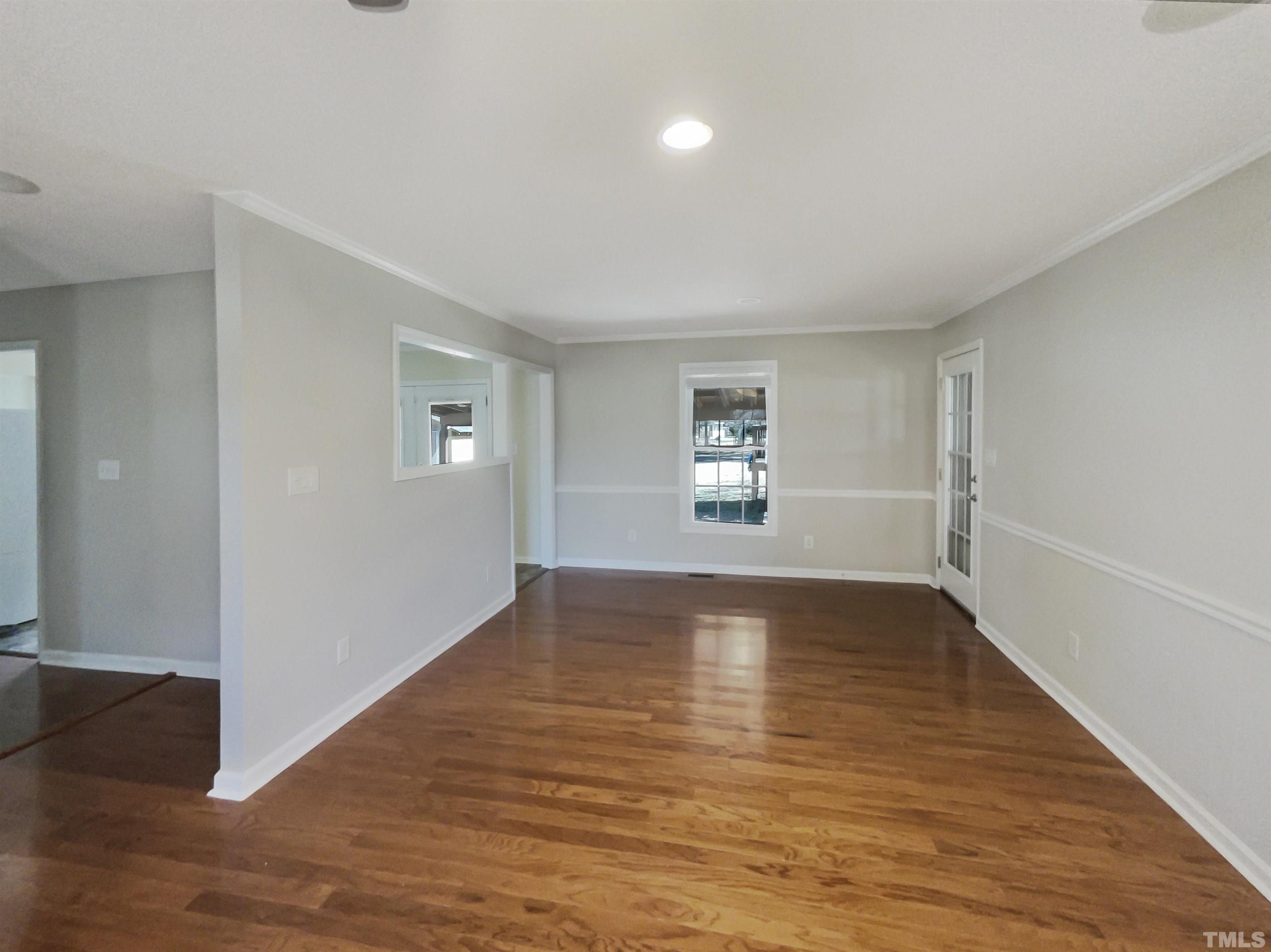 8889 Mt Pleasant Church Road Willow Spring, NC 27592 - Photo 9 of 18 an empty room with wooden floor and windows