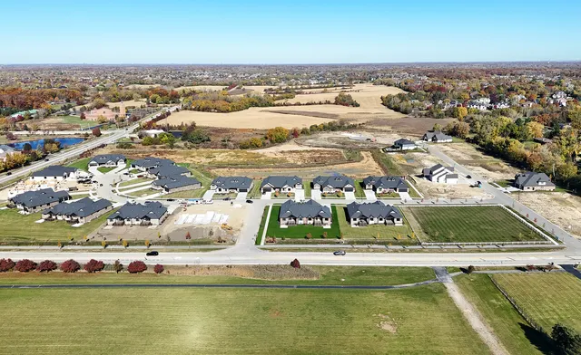 an aerial view of residential houses with outdoor space