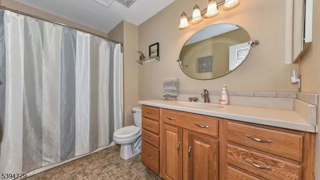 a spacious bathroom with a double vanity sink mirror and toilet