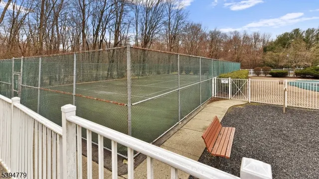 a view of deck with chairs and wooden fence