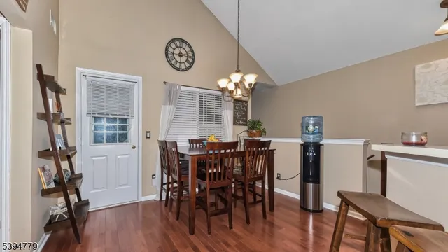 a view of a dining room with furniture and a chandelier