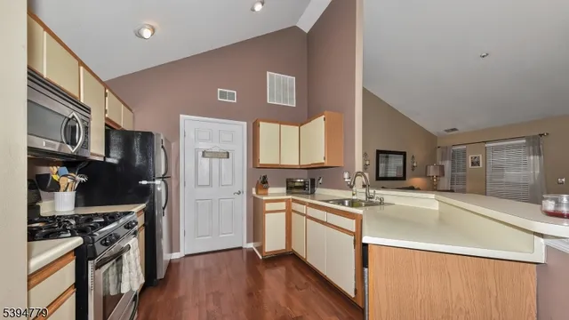 a kitchen with stainless steel appliances a sink stove and refrigerator