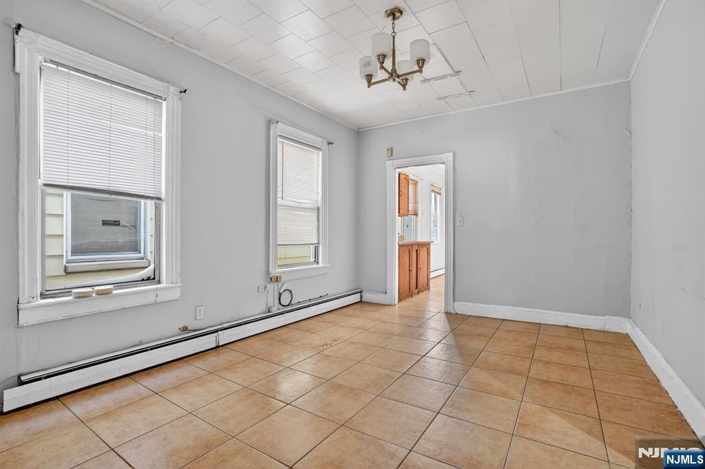 1110 Hampton Place Elizabeth, NJ 07201 - Photo 15 of 23 a view of an empty room with window and chandelier fan