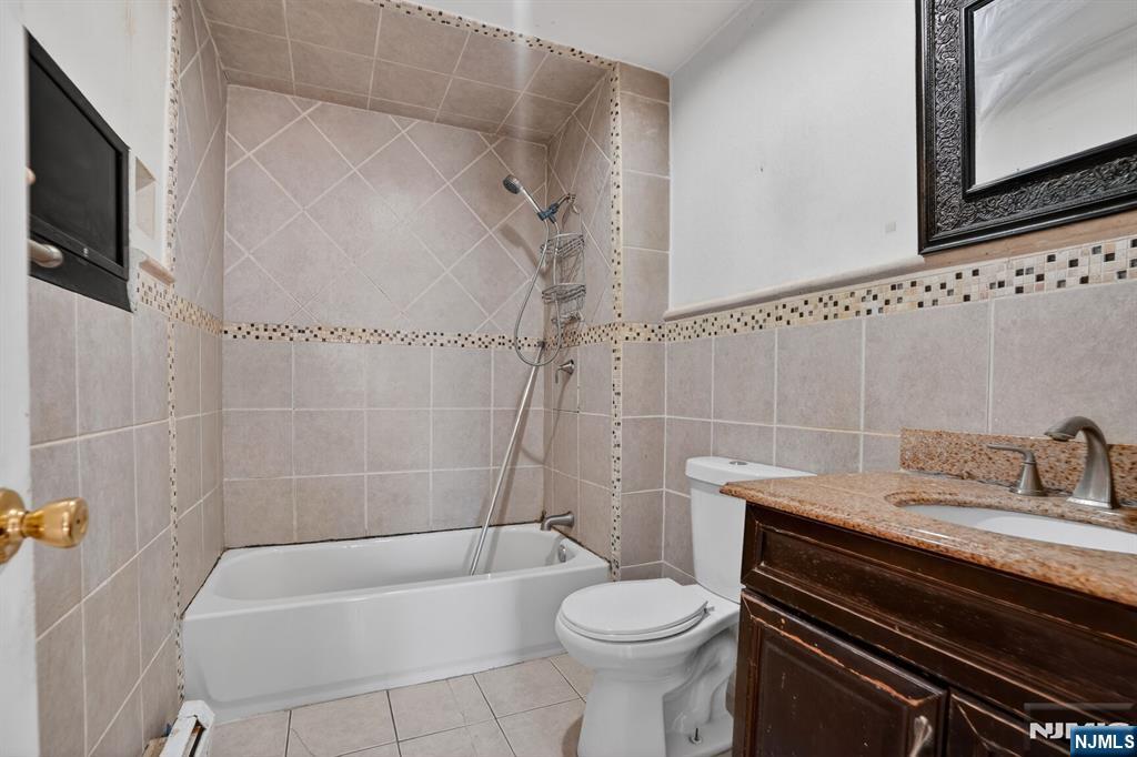 1110 Hampton Place Elizabeth, NJ 07201 - Photo 17 of 23 a bathroom with a sink a toilet a mirror and bathtub
