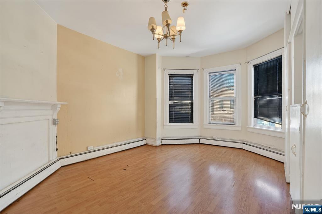 1110 Hampton Place Elizabeth, NJ 07201 - Photo 20 of 23 a view of an empty room with a window and wooden floor