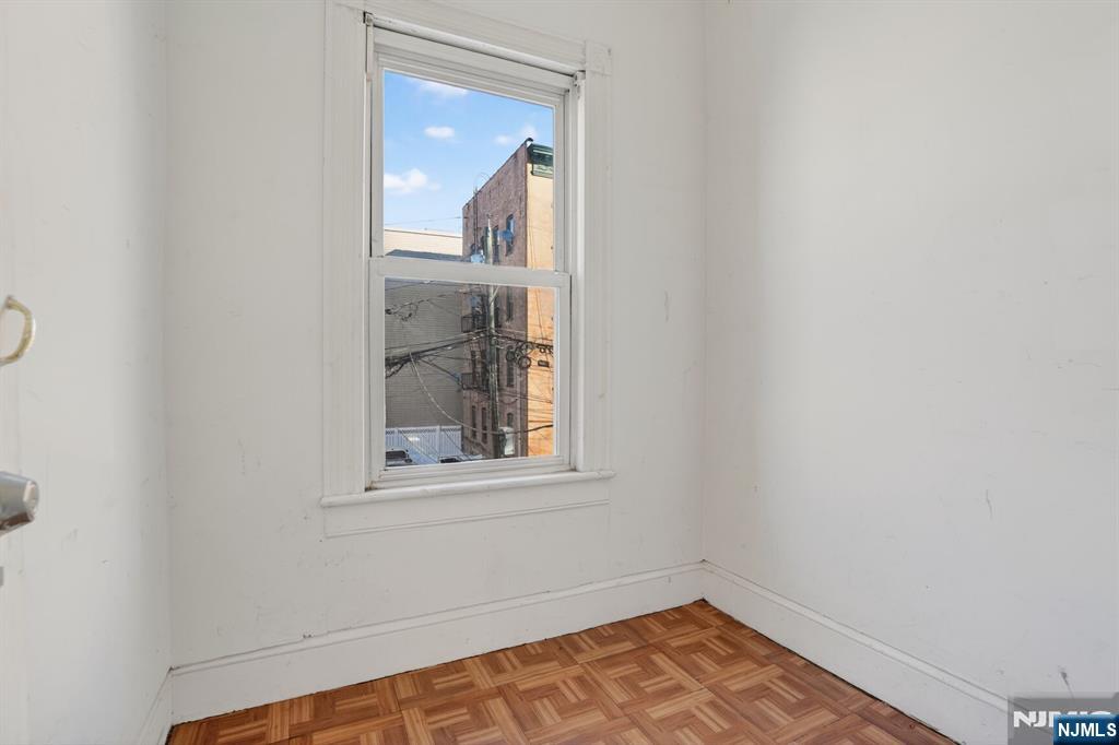 1110 Hampton Place Elizabeth, NJ 07201 - Photo 21 of 23 a view of an empty room with wooden floor and a window