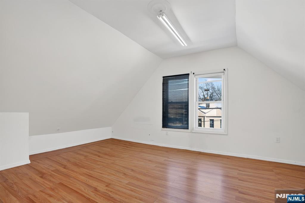 1110 Hampton Place Elizabeth, NJ 07201 - Photo 22 of 23 an empty room with wooden floor and windows