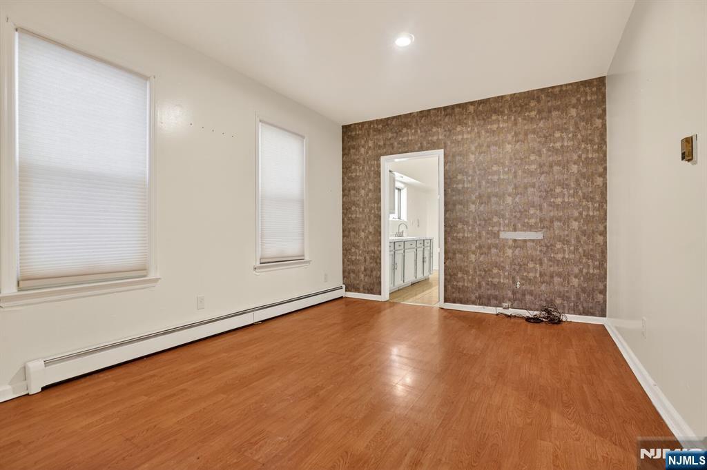 1110 Hampton Place Elizabeth, NJ 07201 - Photo 7 of 23 a view of an empty room with wooden floor and a window